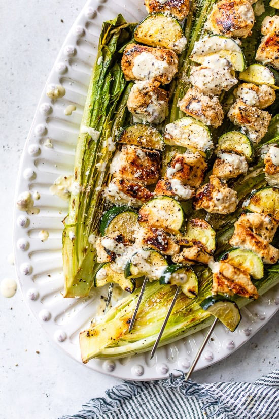 Caesar marinated chicken kabobs with zucchini and grilled romaine